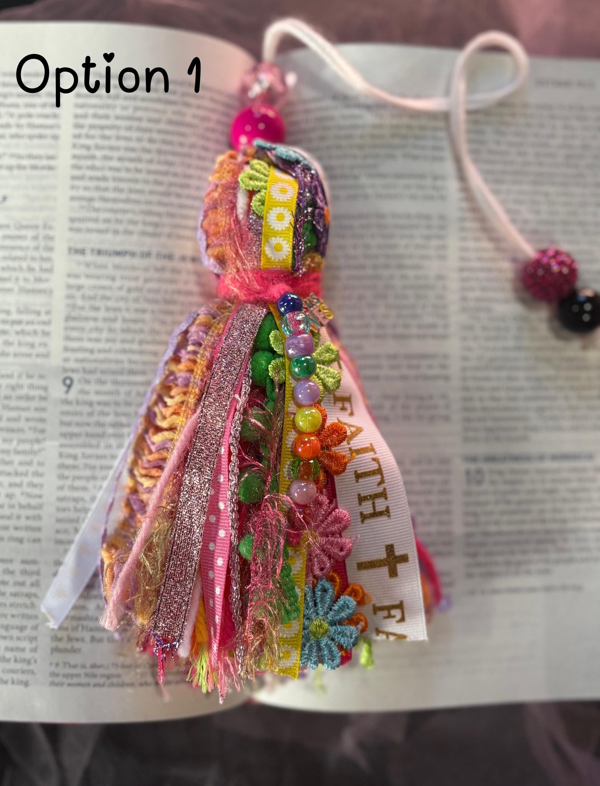 Colorful fabric bookmark with decorative elements on an open book