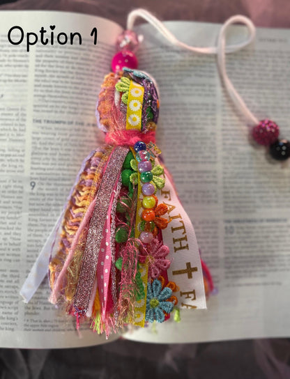 Colorful fabric bookmark with decorative elements on an open book