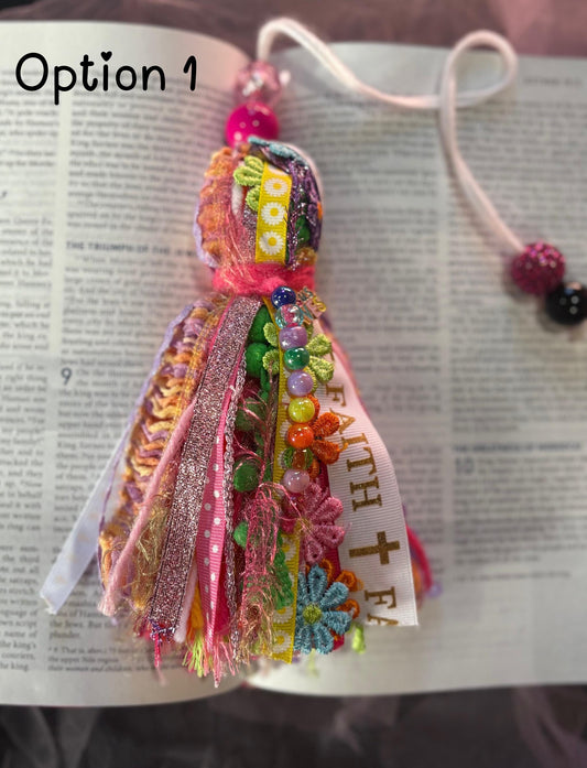 Colorful fabric bookmark with decorative elements on an open book